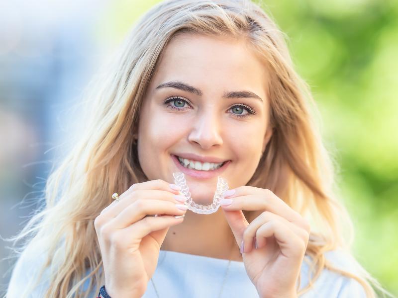 A young holding her new ClearCorrect Clear Aligners in Thornton, CO.